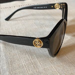 Tory Burch black sunglasses with gold emblem.